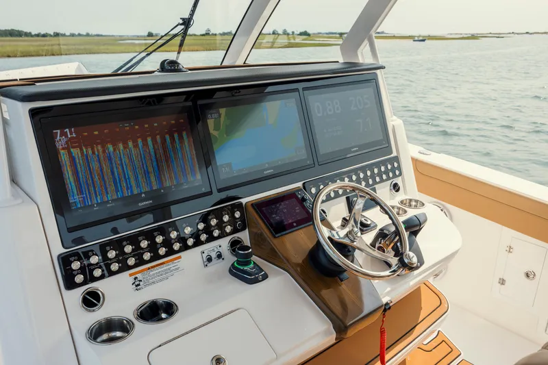 Slide: The Image of Helm of 2025 Caymas 44 CT boat with advanced navigation displays and controls. - 22