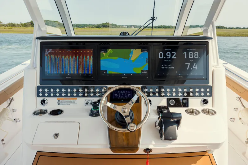 Slide: The Image of Helm of 2025 Caymas 44 CT boat with advanced navigation displays and controls. - 24