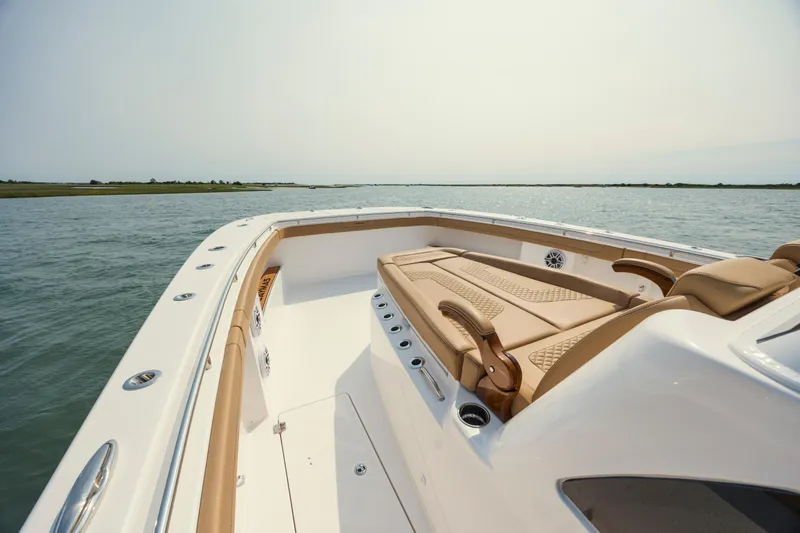 Slide: The Image of 2025 Caymas 44 CT boat with luxurious seating on calm waters. - 25