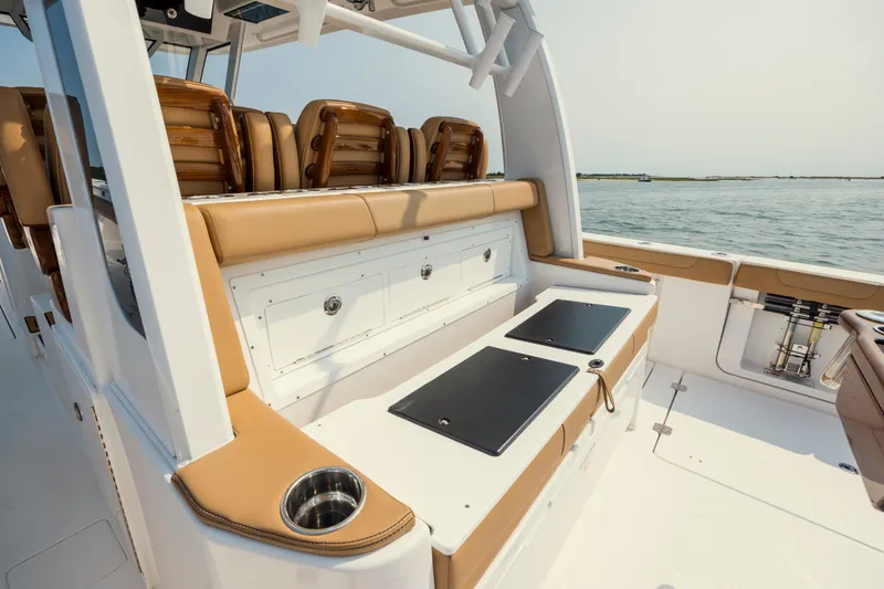 Slide: The Image of 2025 Caymas 44 CT boat interior with tan seating and ocean view. - 26