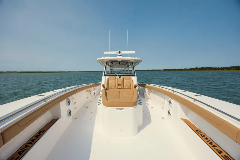 Slide: The Image of 2025 Caymas 44 CT boat on open water, featuring spacious deck and luxurious seating. - 28