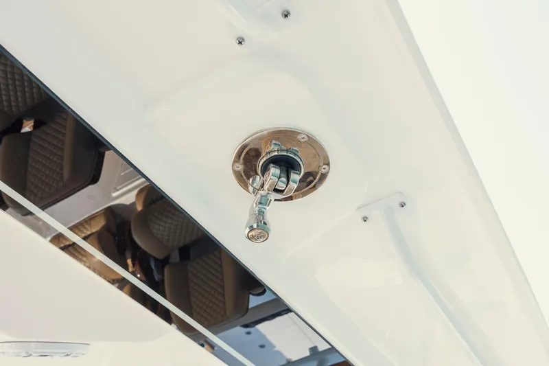 Slide: The Image of Close-up of 2025 Caymas 44 CT boat's fuel cap and sleek white surface. - 29