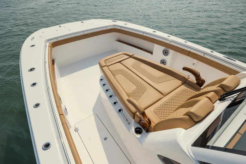 Slide: The Image of 2025 Caymas 44 CT boat with luxurious tan seating on calm water. - 32