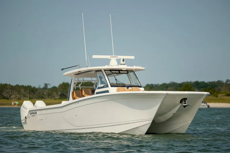 Slide: The Image of 2025 Caymas 44 CT catamaran cruising on a sunny day near the shoreline. - 8