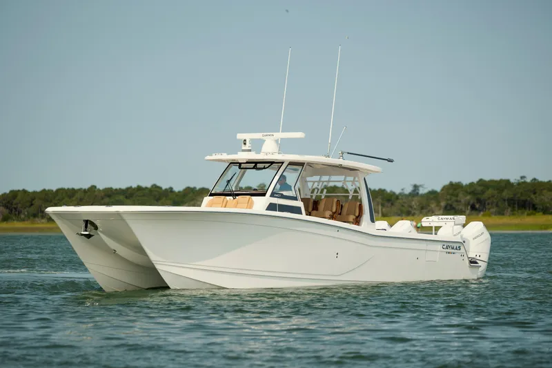 Slide: The Image of 2025 Caymas 44 CT boat cruising on calm water, showcasing sleek design and modern features. - 9
