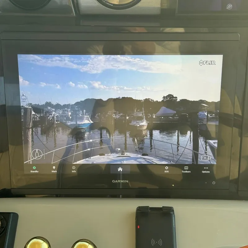 Slide: The Image of Garmin display on 2006 Sea Ray 48 Sundancer showing marina view with boats and clear sky. - 12