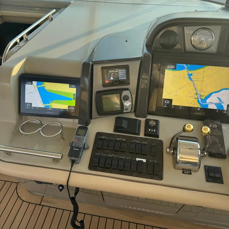 Slide: The Image of Control panel of 2006 Sea Ray 48 Sundancer with navigation screens and controls. - 14