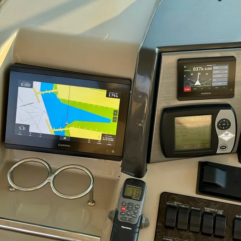 Slide: The Image of Control panel of a 2006 Sea Ray 48 Sundancer with Garmin navigation displays. - 15