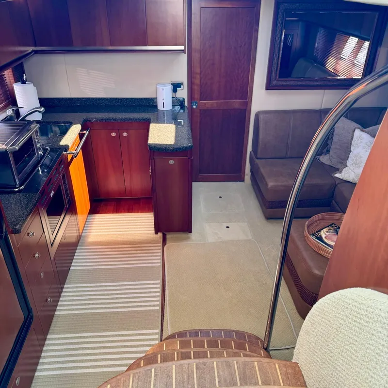 Slide: The Image of Luxurious interior of 2006 Sea Ray 48 Sundancer yacht with modern kitchen and seating area. - 17