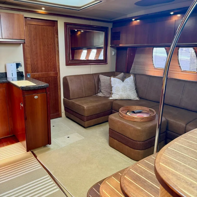 Slide: The Image of Luxurious interior of 2006 Sea Ray 48 Sundancer yacht with plush seating and elegant wood finishes. - 21