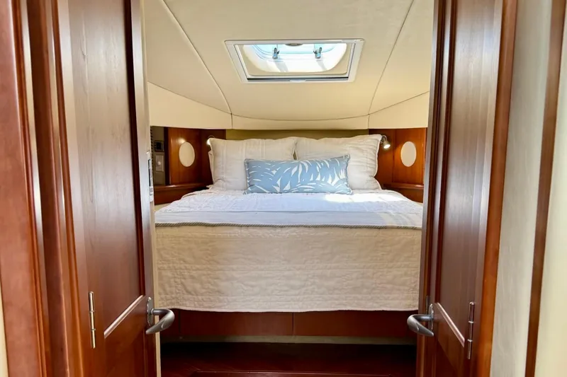 Slide: The Image of Luxurious cabin interior of 2006 Sea Ray 48 Sundancer yacht with skylight and cozy bedding. - 23