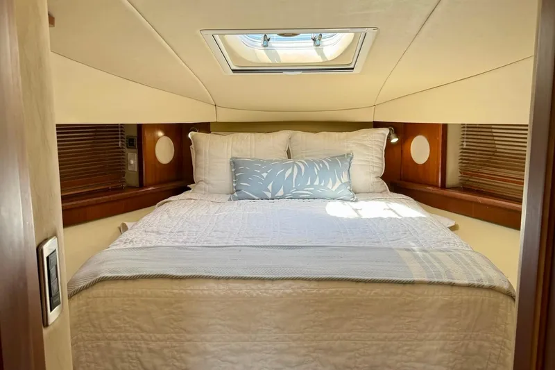 Slide: The Image of Luxurious cabin interior of 2006 Sea Ray 48 Sundancer yacht with skylight and cozy bedding. - 24