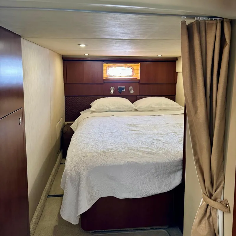 Slide: The Image of Luxurious cabin interior of 2006 Sea Ray 48 Sundancer yacht with cozy bed and elegant decor. - 29