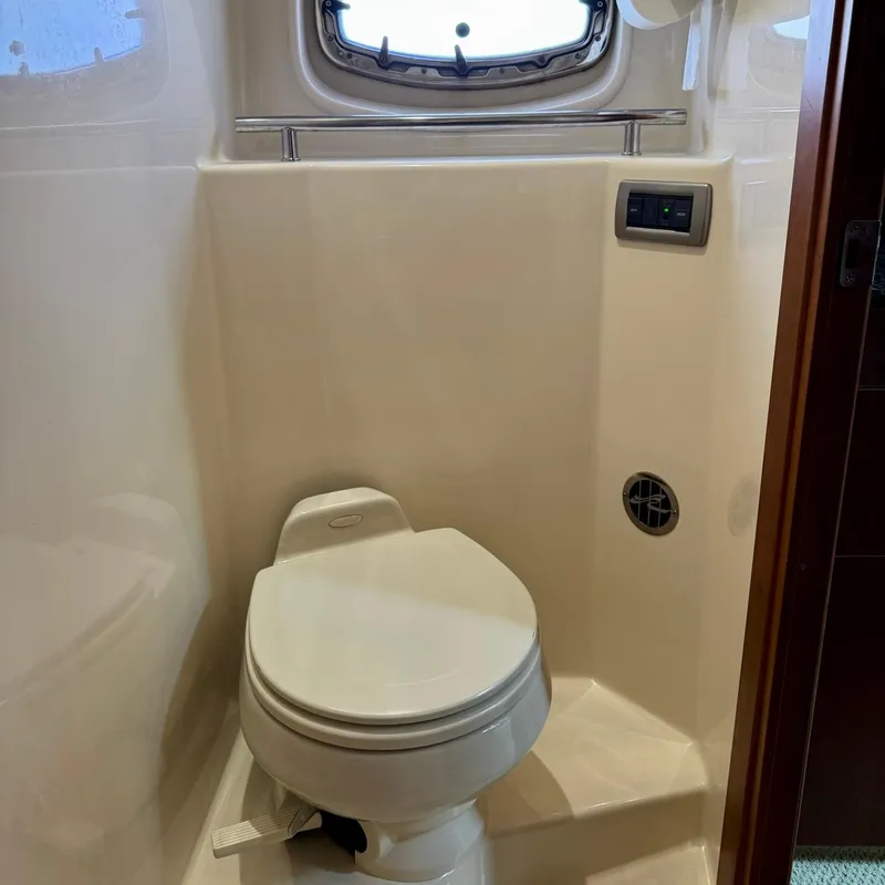 Slide: The Image of Bathroom interior of 2006 Sea Ray 48 Sundancer yacht with toilet and porthole. - 34