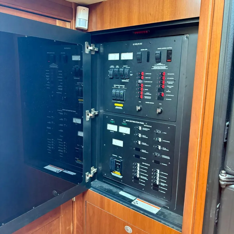 Slide: The Image of Electrical control panel inside 2006 Sea Ray 48 Sundancer yacht, featuring switches and circuit breakers. - 37