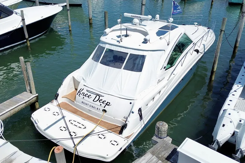 Slide: The Image of 2006 Sea Ray 48 Sundancer yacht docked in marina, named "Knee Deep," Mount Sinai, NY. - 5