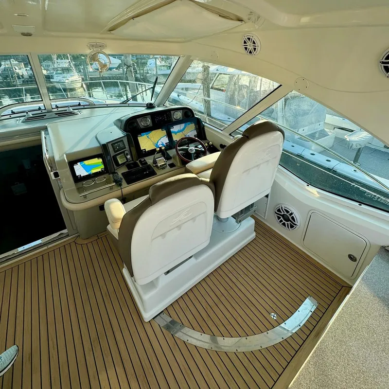 Slide: The Image of 2006 Sea Ray 48 Sundancer helm with dual seats and navigation displays. - 6