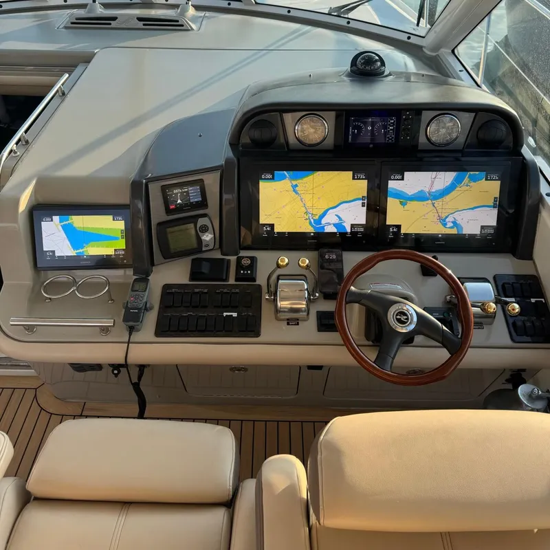 Slide: The Image of 2006 Sea Ray 48 Sundancer helm with navigation screens and controls. - 9