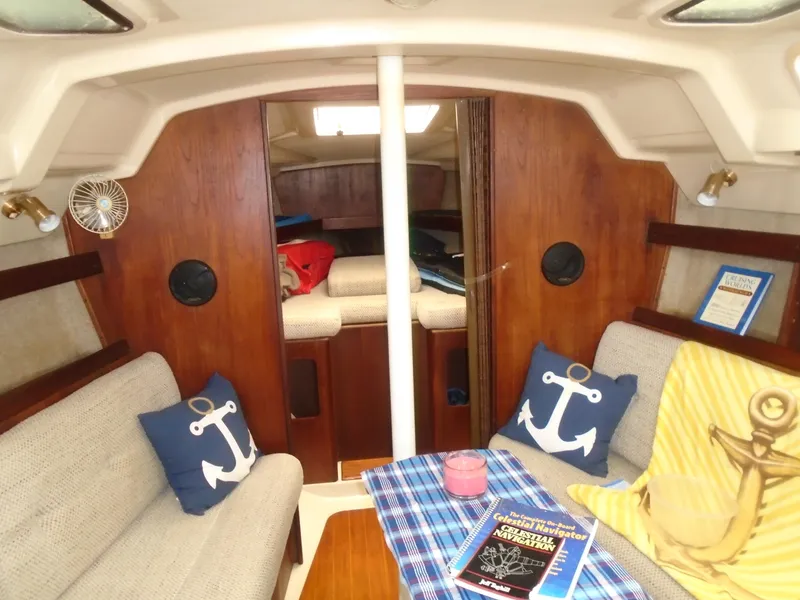 Slide: The Image of Cozy interior of 1989 Hunter 30 sailboat with nautical decor and seating area. - 2