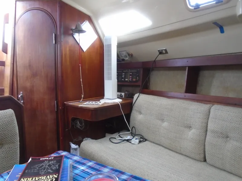 Slide: The Image of Interior of a 1989 Hunter 30 sailboat with cozy seating and navigation equipment. - 4