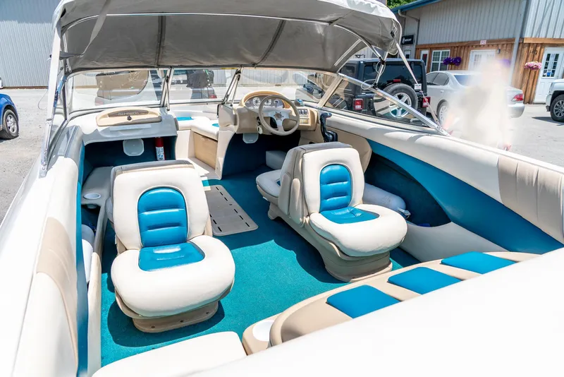 Slide: The Image of Interior of a 1995 Glastron 195 SSV boat with blue and white seating. - 13
