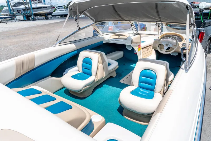 Slide: The Image of 1995 Glastron 195 SSV boat interior with blue and beige seating, steering wheel, and canopy. - 14