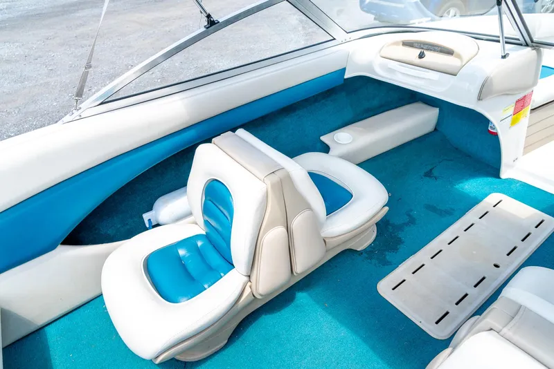 Slide: The Image of Interior of a 1995 Glastron 195 SSV boat with blue and white seating. - 17
