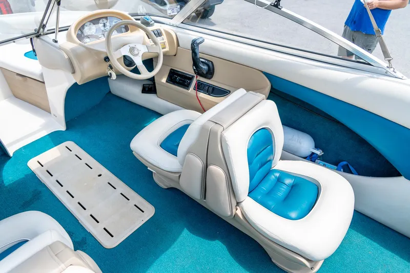 Slide: The Image of Interior of a 1995 Glastron 195 SSV boat with blue and white seating. - 18