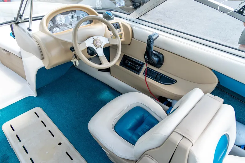 Slide: The Image of Interior of a 1995 Glastron 195 SSV boat, featuring steering wheel and dashboard controls. - 19