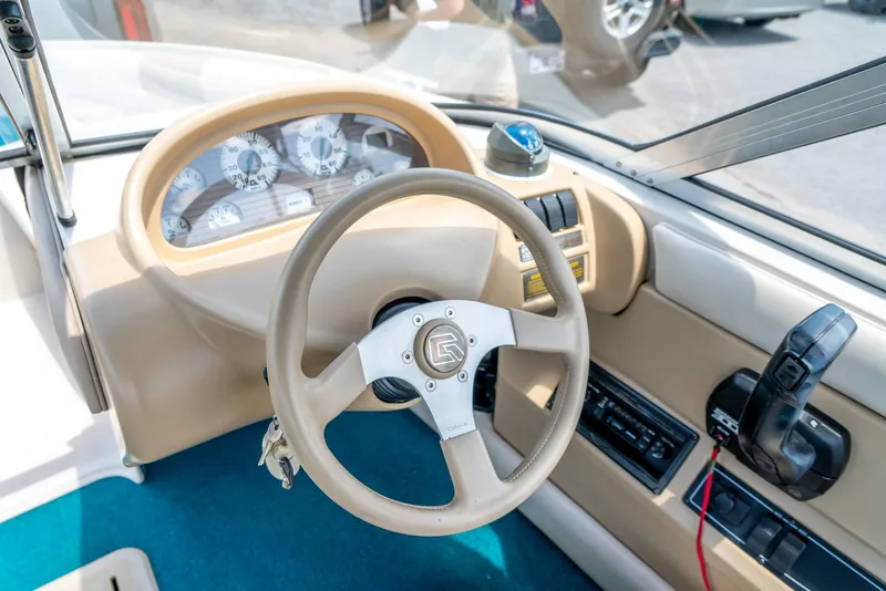 Slide: The Image of Interior of a 1995 Glastron 195 SSV boat showing steering wheel and dashboard controls. - 20