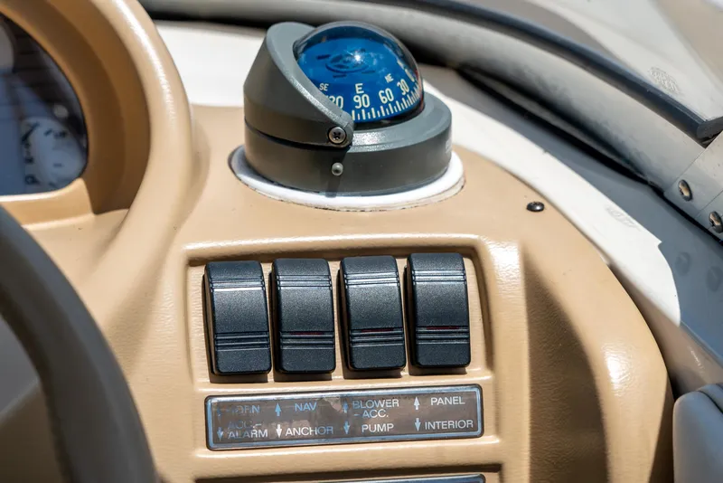 Slide: The Image of Dashboard of a 1995 Glastron 195 SSV boat with compass and control switches. - 22