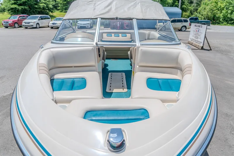 Slide: The Image of 1995 Glastron 195 SSV boat with beige and teal interior, parked outdoors. - 24