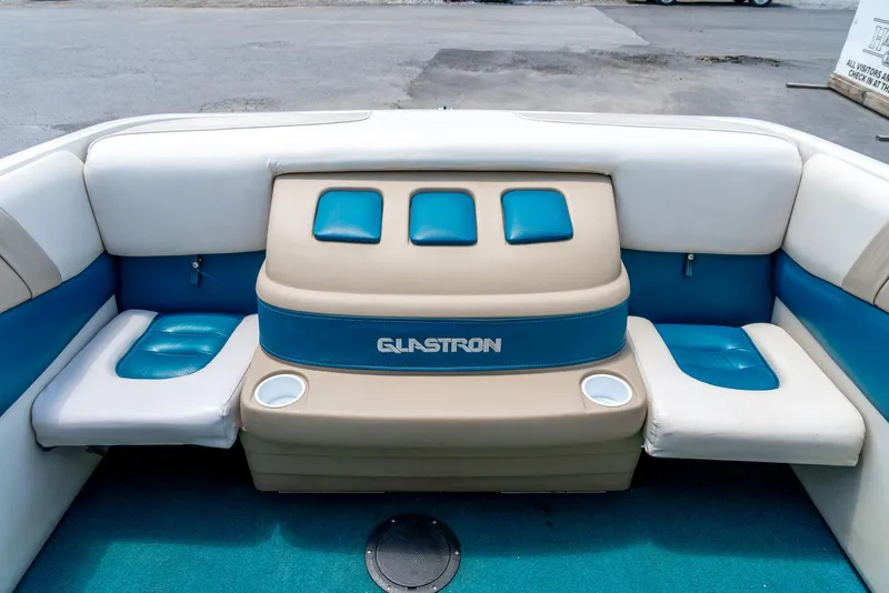 Slide: The Image of 1995 Glastron 195 SSV boat interior with blue and beige seating and cup holders. - 25