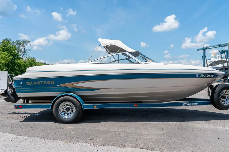 Slide: The Image of 1995 Glastron 195 SSV boat on trailer under blue sky. - 3