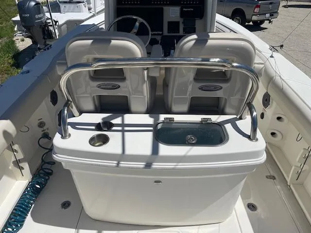 Slide: The Image of 2022 Boston Whaler 25' Outrage boat interior with seating and console. - 19