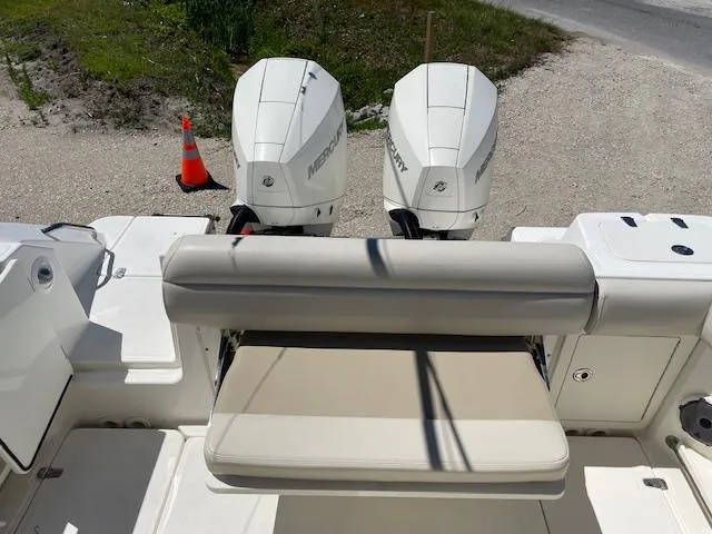 Slide: The Image of 2022 Boston Whaler 25' Outrage boat with dual Mercury engines and cushioned seating. - 20