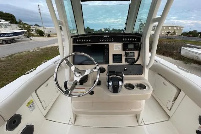 Slide: The Image of 2022 Boston Whaler 25' Outrage boat cockpit with steering wheel and control panel. - 37