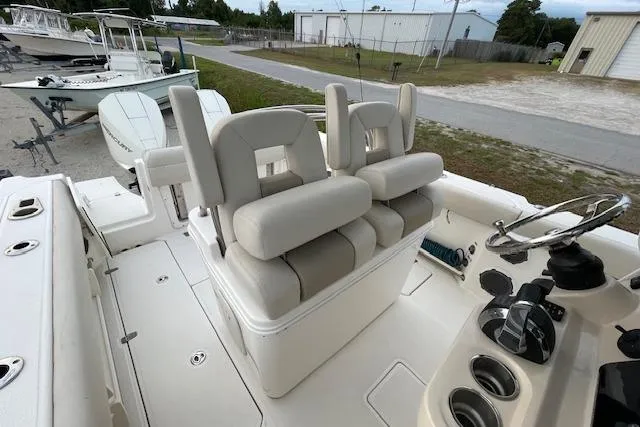 Slide: The Image of 2022 Boston Whaler 25' Outrage boat interior with dual helm seats and steering console. - 38