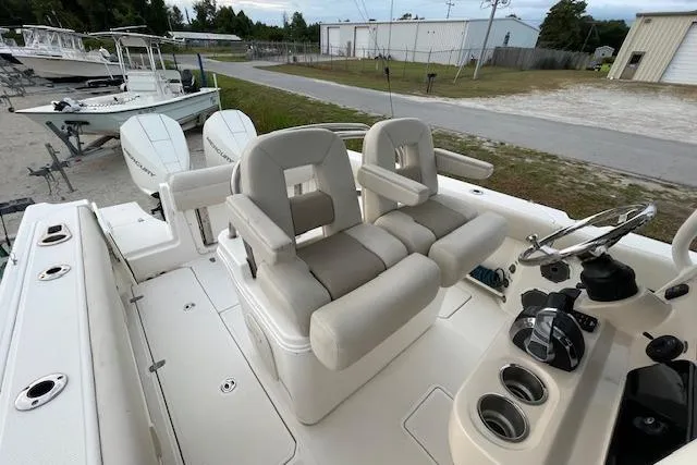 Slide: The Image of 2022 Boston Whaler 25' Outrage boat interior with dual helm seats and steering console. - 39