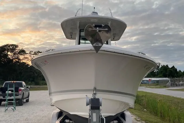 Slide: The Image of 2022 Boston Whaler 25' Outrage boat on trailer at sunset. - 4