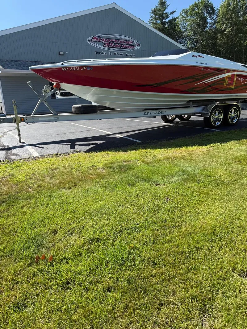 The Image of 2007 Baja 26 Outlaw boat on trailer outside marine supply store. - 1
