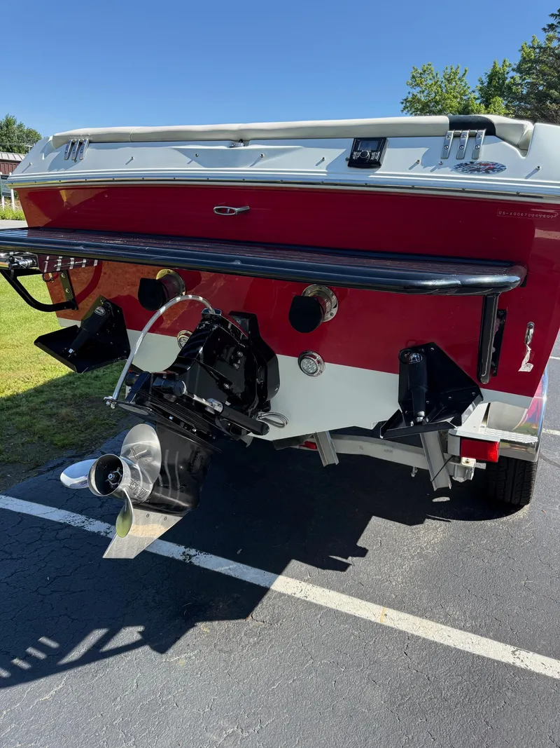 Slide: The Image of 2007 Baja 26 Outlaw boat rear view with propeller and red hull. - 11