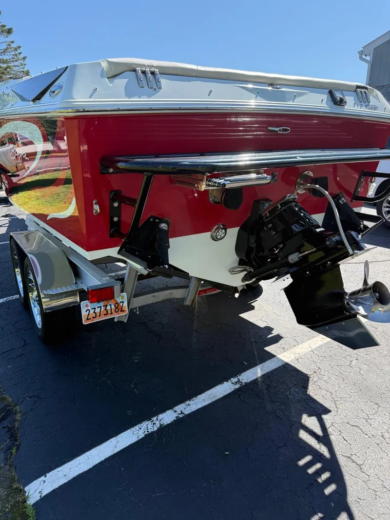 Slide: The Image of 2007 Baja 26 Outlaw boat on trailer, rear view, red and white design. - 12