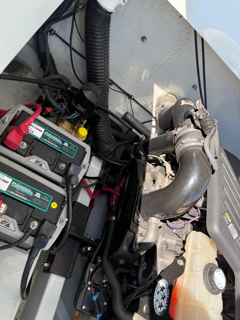Slide: The Image of Engine compartment of a 2007 Baja 26 Outlaw boat, showing batteries and engine components. - 16