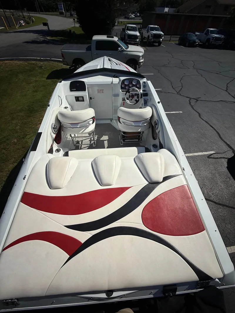 Slide: The Image of 2007 Baja 26 Outlaw boat interior with stylish red and black seating design. - 5