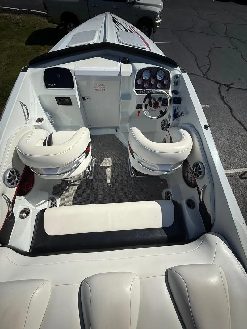 Slide: The Image of 2007 Baja 26 Outlaw boat interior with white seating and control dashboard. - 6