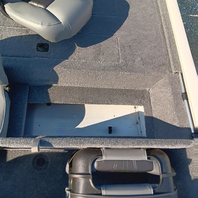 Slide: The Image of 2026 Tracker Pro 170 boat interior with gray seating and storage compartment. - 10