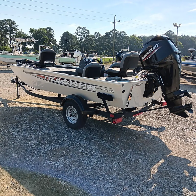 Slide: The Image of 2026 Tracker Pro 170 boat with Mercury engine on trailer, parked outdoors. - 3
