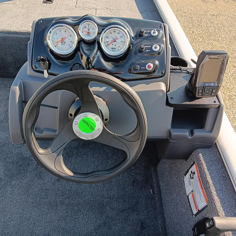 Slide: The Image of 2026 Tracker Pro 170 boat dashboard with steering wheel and gauges. - 8