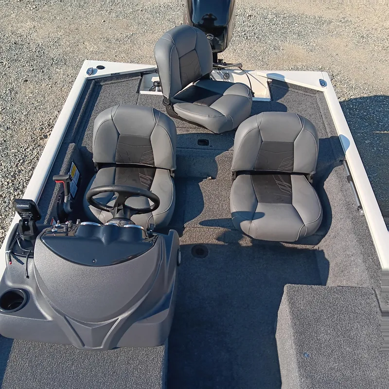 Slide: The Image of 2026 Tracker Pro 170 boat interior with three gray seats and steering console. - 9